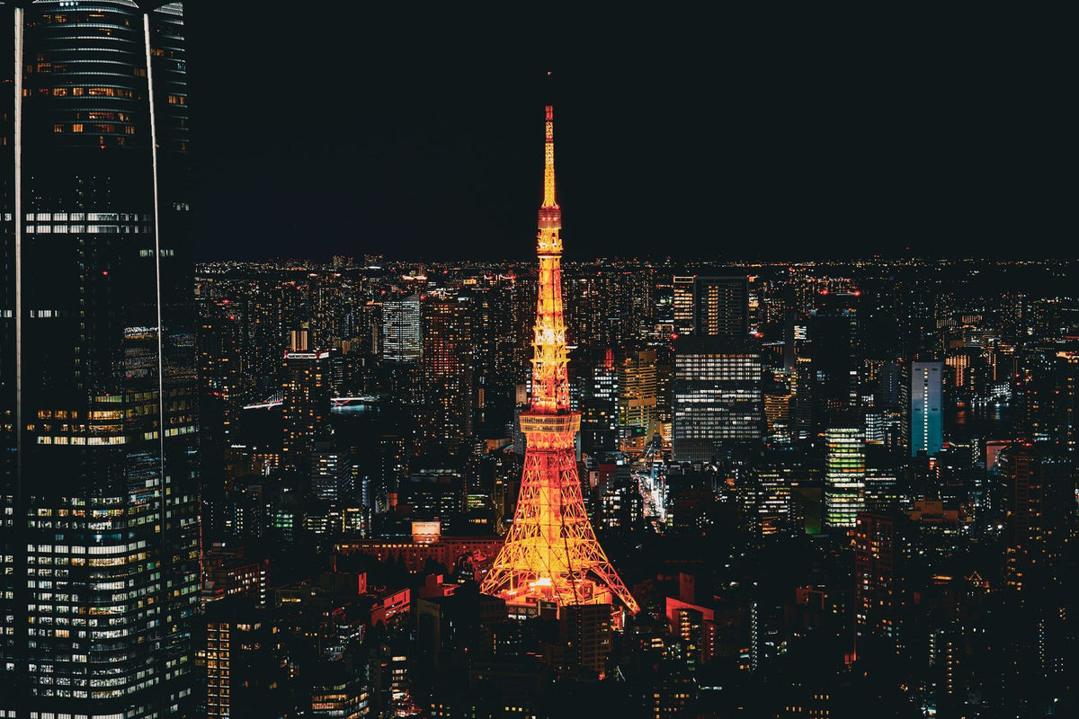 Tokyo Tower lit up above the Tokyo city skyline at night, Japan